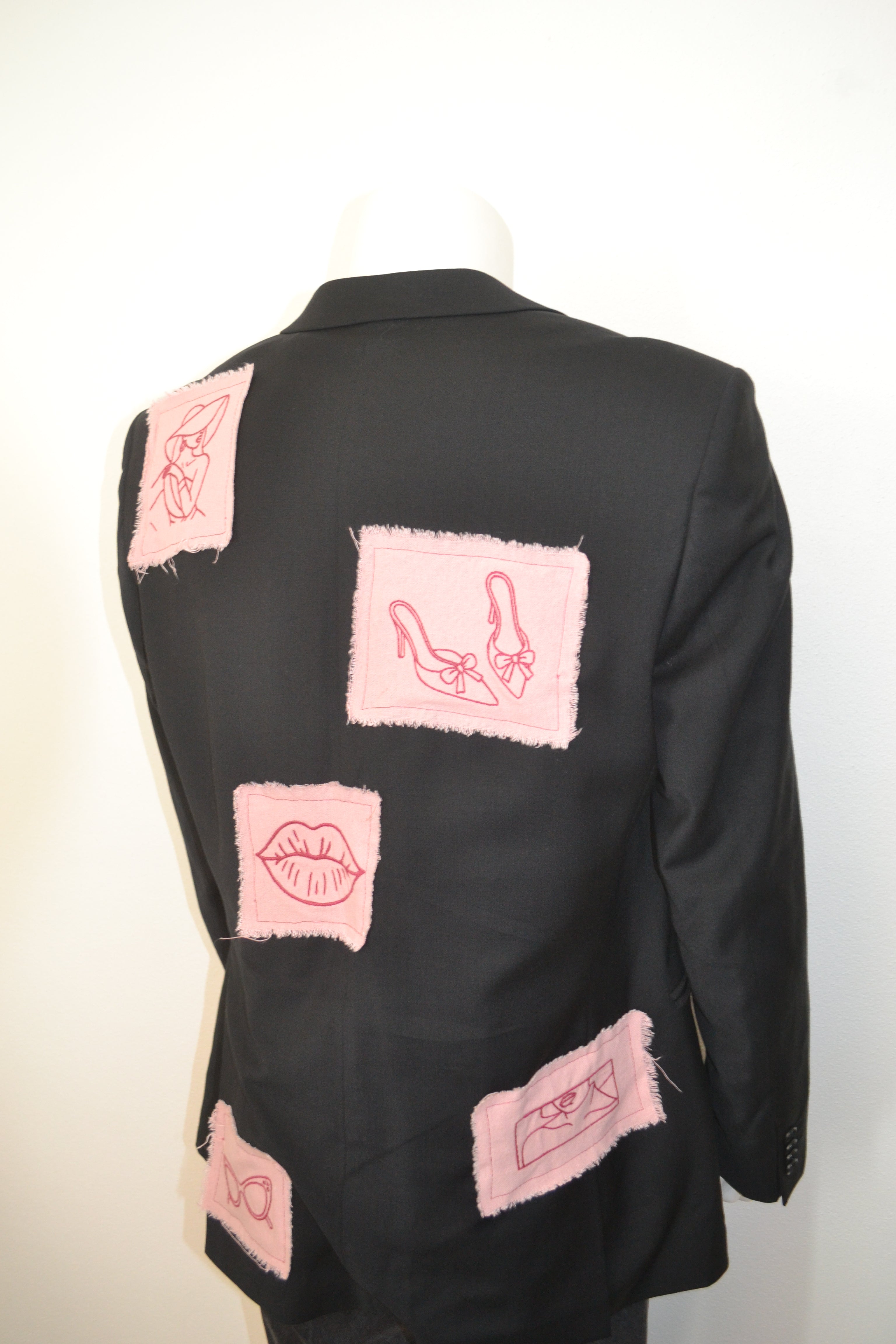 Sort blazer bagfra med lys erøde patches og broderede motiver
